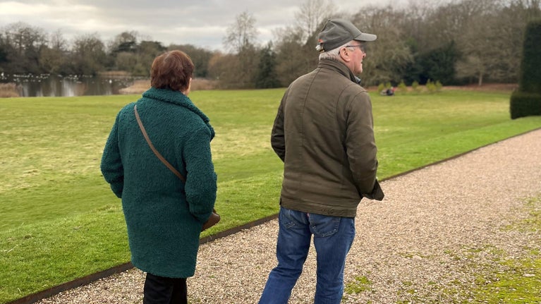 Two people walking in the gardens at Sudbury